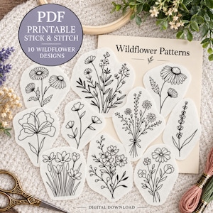 May include: A set of ten white stick and stitch embroidery stabilizers featuring black line art of various wildflowers. The paper packaging is labeled Wildflower Patterns and PDF Printable Stick & Stitch 10 Wildflower Designs.