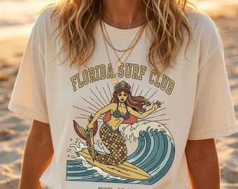 Camiseta del Florida Surf Club, camiseta vintage de surf con sirena, camiseta con estampado costero de playa, estética oceánica veraniega, regalo retro para surfistas, camiseta unisex