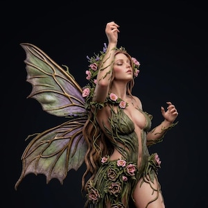 May include: A detailed sculpture of a fairy with flowing brown hair, adorned with a floral crown and roses. Her green and brown attire is embellished with leaves and roses, and she has large, detailed wings. The fairy is posed against a black background.