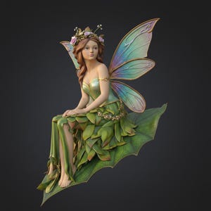 May include: A detailed figurine of a fairy with green and gold attire, seated on a large leaf. The fairy has delicate, iridescent wings, a floral crown, and long brown hair. The dress is designed with leaf-like details, and the overall aesthetic is whimsical.