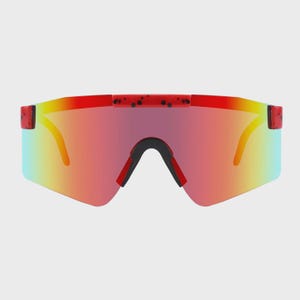 May include: Shield-style sunglasses featuring a single continuous lens with a gradient red, orange, and yellow tint. The top frame bar is red with a black speckled pattern, and the nose bridge area is reinforced with black rubberized padding.
