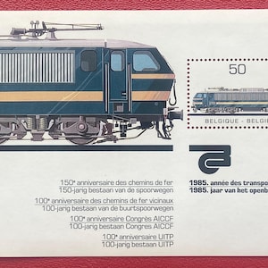 May include: A commemorative postage stamp sheet featuring a dark blue and yellow electric locomotive. The design includes the number 50, the text BELGIQUE - BELGIË, and various inscriptions marking the 150th and 100th anniversaries of railways.