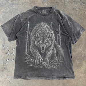 May include: A charcoal grey short-sleeve t-shirt featuring a detailed white graphic print of a snarling wolf in a forest setting. The fabric has a washed, faded appearance. The word Pepper is printed in black at the bottom left corner.