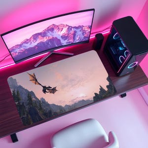 Puede incluir: Una configuración de escritorio de computadora con un monitor curvo, una computadora de escritorio y una alfombrilla de ratón. La alfombrilla de ratón muestra un dragón volando sobre montañas al atardecer. El escritorio y la habitación están iluminados con luz rosa.
