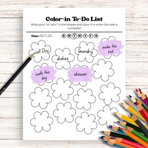 May include: A white Color-in To-Do List with flower-shaped boxes for tasks. The list includes tasks like "call Doc," "laundry," and "make the bed." A black pencil and a collection of colored pencils are also visible.