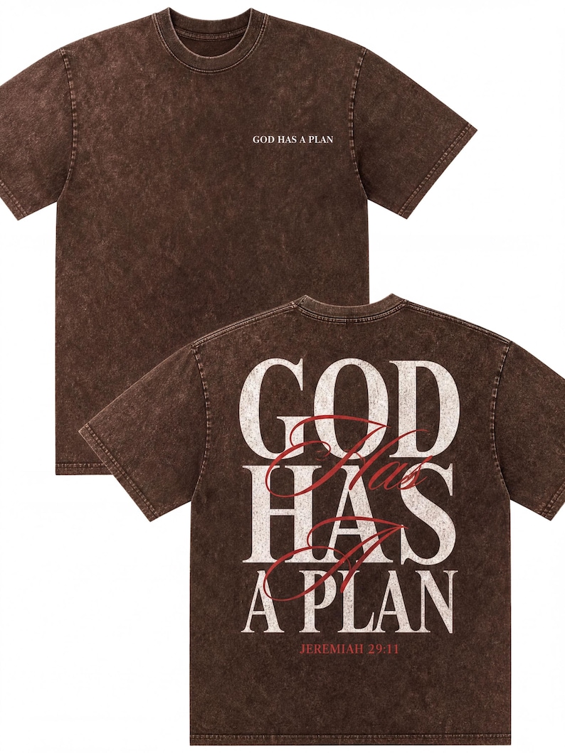 A brown t-shirt with the text "GOD HAS A PLAN" printed on the back in white and red lettering.