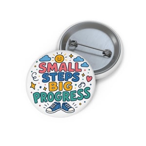 May include: A round pinback button featuring the text SMALL STEPS BIG PROGRESS in pink, blue, yellow, and green. The design includes a smiling sun, blue clouds, a small pink heart, yellow stars, and a pair of blue trainers at the bottom.