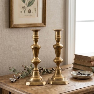 May include: A set of three ceramic mugs with a speckled, matte finish in cream, light grey, and dark grey. Each mug has a simple, minimalist design and a rounded handle.