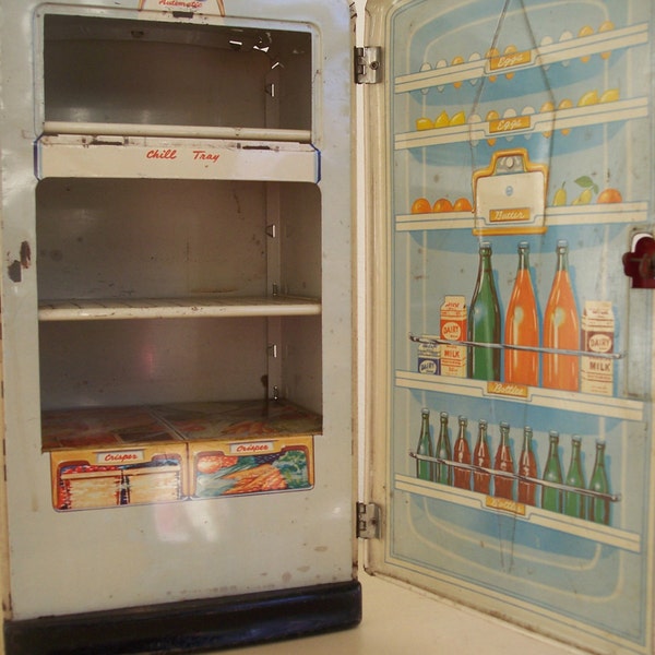 1940s- 1950s tin litho toy refrigerator. Doll-sized and cute for a display. Marx.