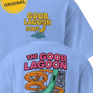 May include: Light blue t-shirt with "GOOB LAGOON STAFF" in yellow on the front and "THE GOOB LAGOON" with a water slide graphic on the back. The shirt has a round neck and short sleeves.