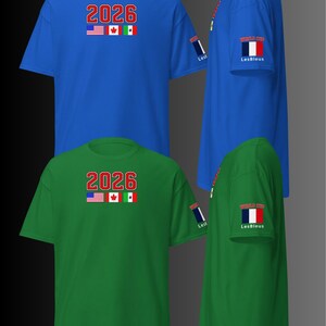 May include: Royal blue and green short-sleeve t-shirts. Each shirt displays the number "2026" above the flags of the United States, Canada, and Mexico. The sleeve features a flag and the text "LesBleus".
