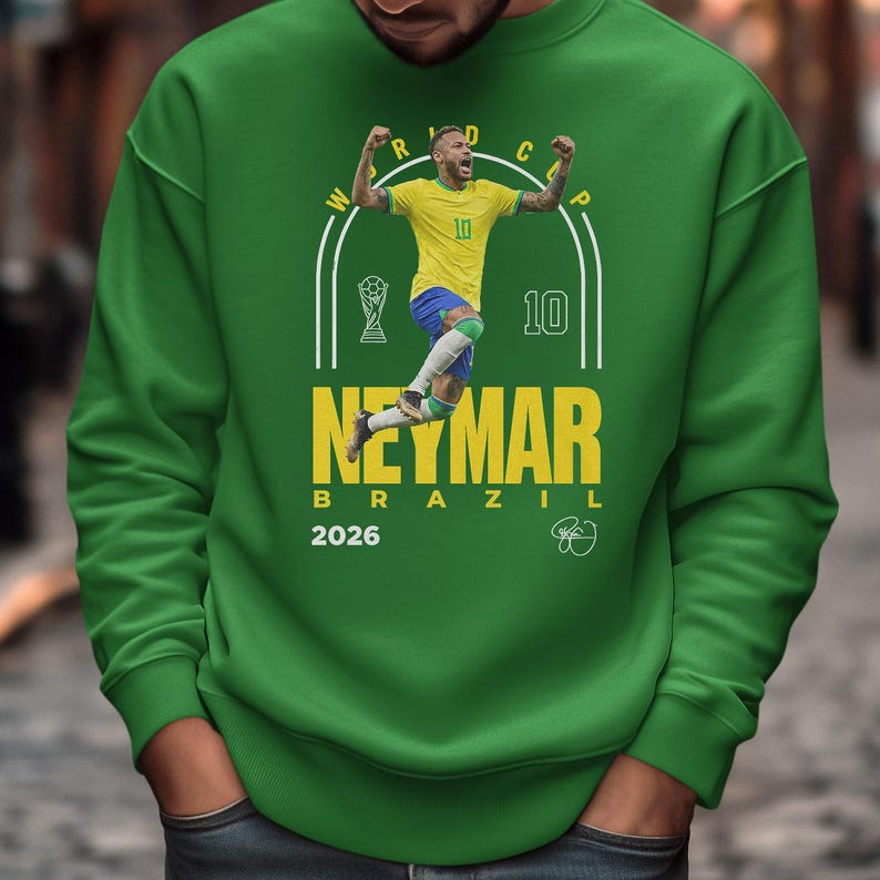 A man wearing a green sweatshirt with a graphic of a soccer player and text related to the World Cup.