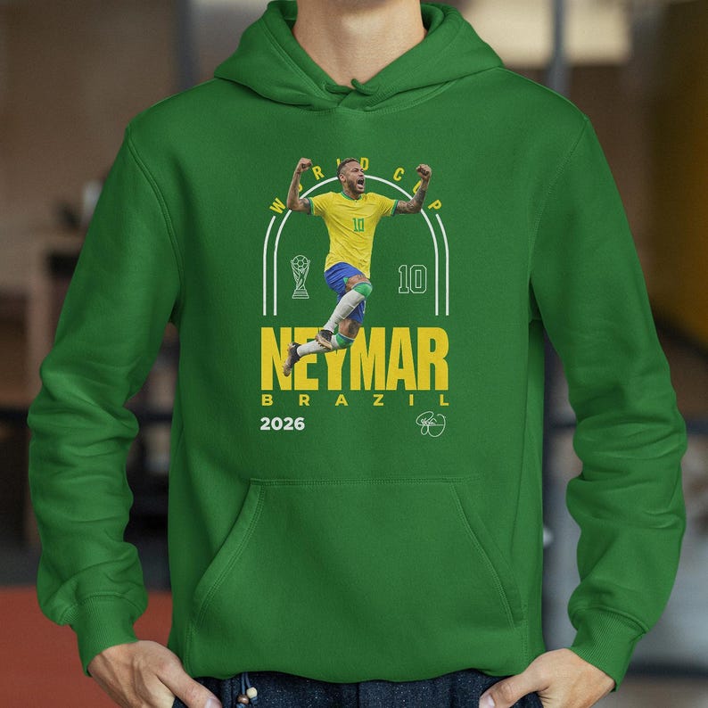 A green hoodie with a graphic of a soccer player in yellow and blue, along with the text "NETMAR BRASIL" and the year "2026".