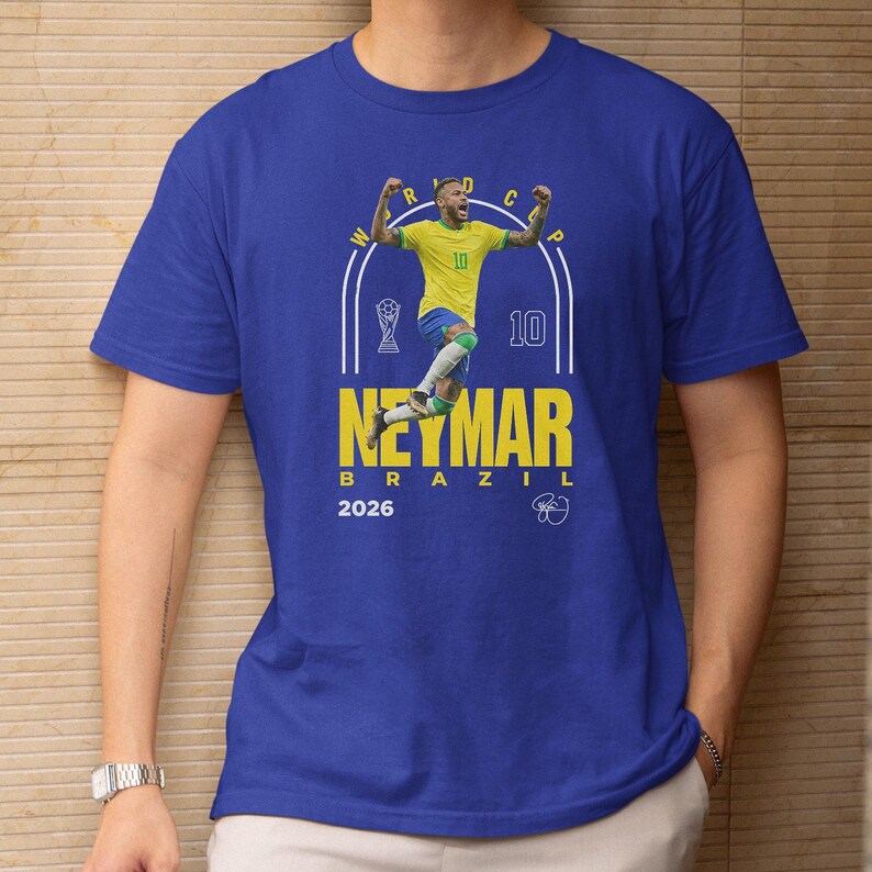A blue t-shirt with a graphic design featuring a soccer player in a yellow jersey, along with text and a number.