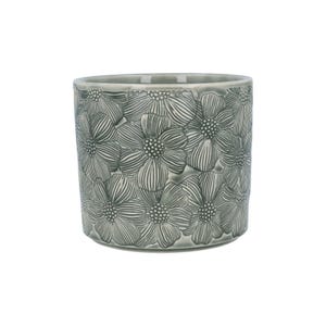 May include: A grey ceramic plant pot featuring a repeating floral design. The pot is cylindrical with a slightly flared top. The flowers are embossed, creating a textured surface. Suitable for indoor or outdoor use, it measures approximately 15 cm in height.