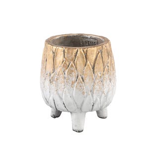 May include: A small, three-legged planter featuring a textured, petal-like exterior design. The finish transitions from a metallic gold at the top rim to a distressed white at the base. A small rectangular stamp with the text PTMD is visible inside.