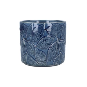 May include: A blue ceramic plant pot with a glossy finish. The pot has a raised leaf pattern across its surface. The leaves have a textured, dotted design. Suitable for indoor or outdoor use. The pot is cylindrical in shape.