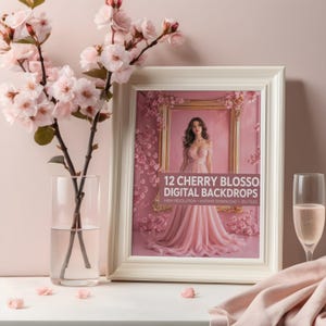 May include: A framed print with the text "12 Cherry Blossom Digital Backdrops" features a woman in a pink dress. A glass vase with cherry blossom branches and a champagne glass with a pink drink are in the foreground. The color scheme is soft pink.