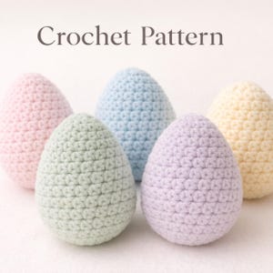 May include: Five crocheted egg shapes in pastel colors: pink, light blue, green, lavender, and yellow. The eggs are arranged in a group, with the text "Crochet Pattern" at the top. The eggs are made with a tight stitch pattern.