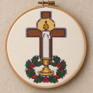 May include: A cross-stitch embroidery in a circular wooden hoop featuring a brown cross centered behind a white candle with a yellow flame. A green holly wreath with red berries encircles the base of the candle and the bottom of the cross.
