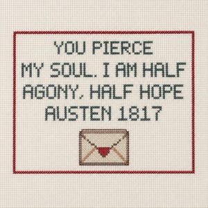May include: A cross-stitch embroidery on cream fabric featuring a red border and the black text: YOU PIERCE MY SOUL. I AM HALF AGONY, HALF HOPE AUSTEN 1817. Below the text is a stitched envelope icon with a red heart seal on the flap.