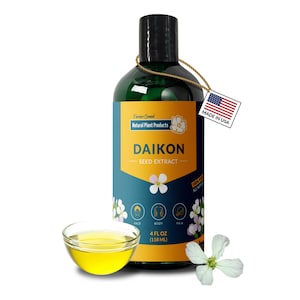 May include: A green bottle of Daikon Seed Extract with a yellow and blue label, a small glass bowl of yellow liquid, and a white flower. The label reads "Farmer Owned Natural Plant Products" and "Made in USA."