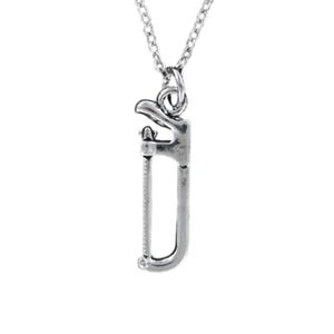 May include: A silver necklace with a saw pendant. The saw is a small, detailed replica of a hand saw.