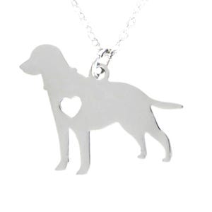 May include: A silver-toned metal necklace featuring a pendant shaped like a dog in profile. The dog silhouette includes a small heart-shaped cutout in the center of its body. The pendant is attached to a delicate silver-toned link chain.