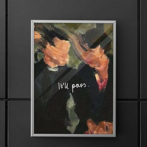 May include: A framed abstract art print with a silver frame. The artwork features a dark background with brushstrokes of orange, green, and black. The text "I'll pass." is written in white script.