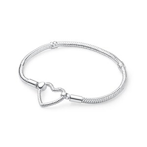 May include: A silver-toned snake chain bracelet featuring a heart-shaped clasp. The bracelet has a flexible, textured link design with two fixed stations along the band and a polished heart-shaped closure that connects the two ends of the chain.
