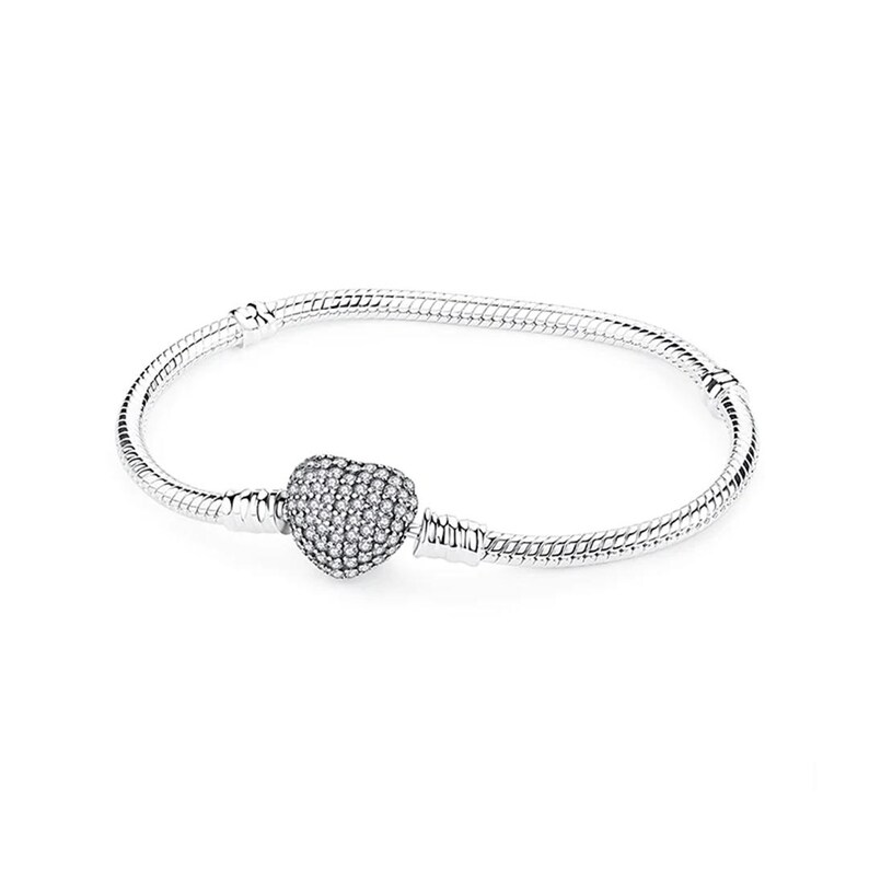 May include: A silver snake chain bracelet featuring a heart-shaped charm covered in small, clear, sparkling stones. The bracelet has a smooth, flexible metal band with a secure clasp mechanism, designed to hold charms in a fixed position.