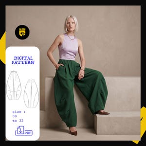 Peut inclure: Un patron de couture numérique pour un pantalon large taille haute vert foncé. Le patron couvre les tailles 00 à 32 et est disponible en téléchargement PDF. L'image montre le pantalon fini porté avec un haut sans manches lilas.