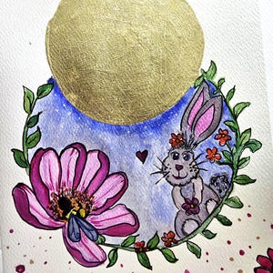 May include: Watercolor painting featuring a gold sun, a purple and pink flower with a bee, and a gray bunny with a floral crown. The bunny is surrounded by a green vine with red flowers, set against a blue sky.