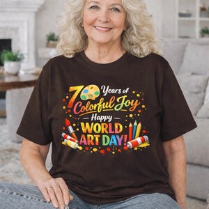 May include: A white ceramic mug with a black handle and the text "But First, Coffee" in a black, bold font. The mug is sitting on a white surface.