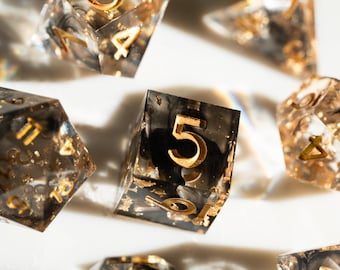 Sharp Edge DND Dice Set – Black dice with gold flakes and Gold Numbers – 7pc Polyhedral RPG Dice for Dungeons and Dragons