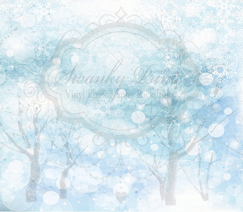 May include: A digital background image with a watercolor effect. The background is a light blue color with white snowflakes and white circles. There are also two trees in the background, which are also white. The text "Swanky Prints Vinyl Photography Backdrops" is in the center of the image.