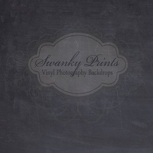 May include: A black chalkboard background with a white decorative border and a gray oval label with the text "Swanky Prints Vinyl Photography Backdrops".