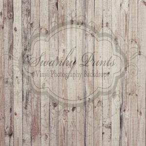 May include: A light brown wood backdrop with a faded white overlay of a decorative frame with the text "Swanky Prints Vinyl Photography Backdrops".
