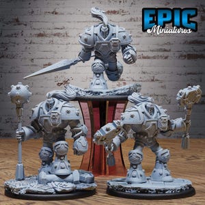 May include: A collection of gray miniature figurines of armored warriors, some holding weapons like a spear and maces. The figurines are on a wooden surface with a brick background. The text "EPIC Miniatures" is visible.