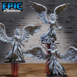 May include: Multiple gray miniature angel figurines with large feathered wings, flowing robes, and detailed facial features. The figurines are displayed on decorative stands. The text "EPIC Miniatures" is visible in the upper left corner.