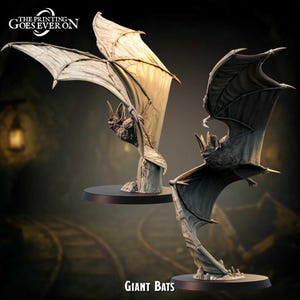 May include: Two detailed bat sculptures with outstretched wings, one in light beige and the other in dark gray. The bats are mounted on black circular bases. The text "THE PRINTING GOES EVER ON" and "GIANT BATS" are visible.