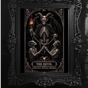 May include: Black framed tarot card art print depicting a skeletal devil with a torch, and two chained skeletons. The card reads "THE DEVIL" with text "Temptation, Bondage, Obsession". The frame has intricate detailing.
