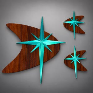 May include: A set of three wall decorations featuring dark brown wood-grain boomerang shapes overlaid with bright turquoise metal starburst accents. Each piece displays a sharp, multi-pointed star design centered on the curved wooden base.