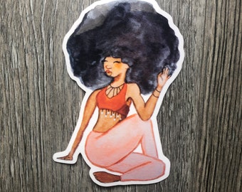 May include: A watercolor illustration of a woman with an afro hairstyle sitting in a yoga pose. She is wearing a red top with a beaded fringe and pink pants.