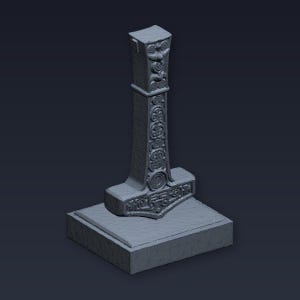 May include: A 3D-rendered model of Thor's hammer, Mjolnir, in a gray color. The hammer features intricate carvings and is set on a rectangular base. The design includes detailed patterns and symbols.