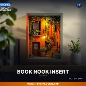 May include: A miniature diorama of a European street scene, framed within a rectangular structure. The scene features a brick building with a door, window, and staircase, adorned with greenery. The text "BOOK NOOK INSERT" is displayed at the bottom, along with "INSTANT DIGITAL DOWNLOAD".