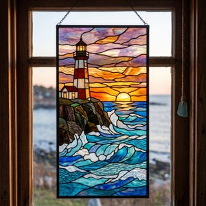 May include: A rectangular stained glass panel featuring a lighthouse on a rocky cliff overlooking a turbulent ocean at sunset. The scene includes a red and white lighthouse, dark cliffs, blue waves with white foam, and a vibrant orange and purple sky.