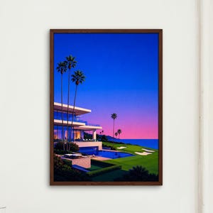 May include: A framed rectangular wall art print depicting a modern multi-level house with a swimming pool, green lawn, and tall palm trees against a vibrant blue and pink sunset sky, overlooking a dark blue ocean horizon in the distance.