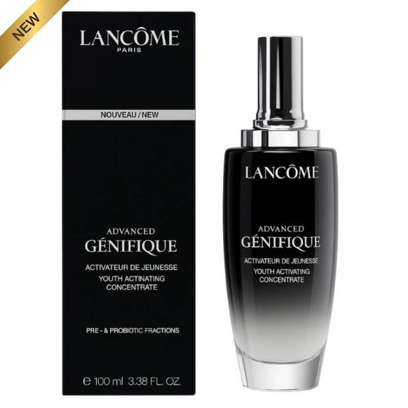 May include: A black and silver Lanc&ocirc;me Advanced G&eacute;nifique Youth Activating Concentrate bottle and box set. The box reads "Nouveau/New" and "e 100 ml 3.38 FL. OZ.". The bottle has a silver pump and a gradient effect.