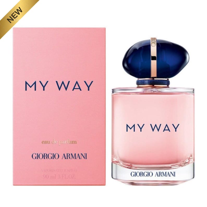 May include: A perfume bottle and box set. The box is light pink with the words "MY WAY" and "GIORGIO ARMANI" in navy blue. The perfume bottle is a clear, rectangular shape with a dark blue cap and the words "MY WAY" and "GIORGIO ARMANI" in navy blue.